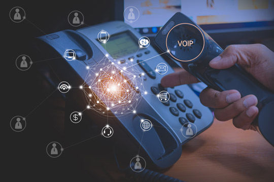 Resources/2/slider-shutterstock-stock-photo-hand-of-man-using-ip-phone-with-flying-icon-of-voip-services-and-people-connection-voip-and.jpg